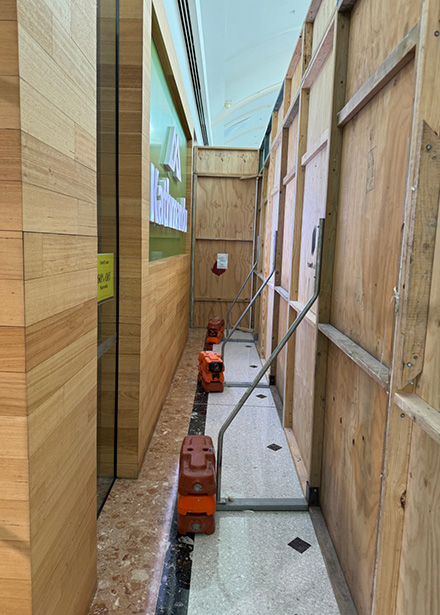 West Maintain worker installs hoarding at a vicinity shopping centre